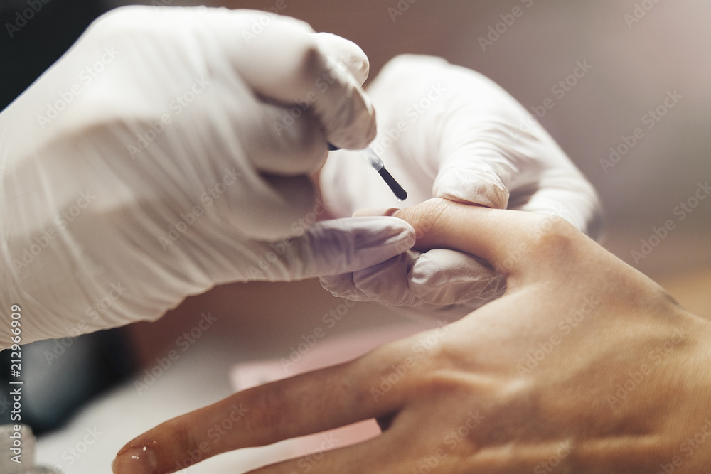 Closeup shot of a woman receiving a manicure by a beautician. Closeup shot of a woman receiving a manicure by a beautician.