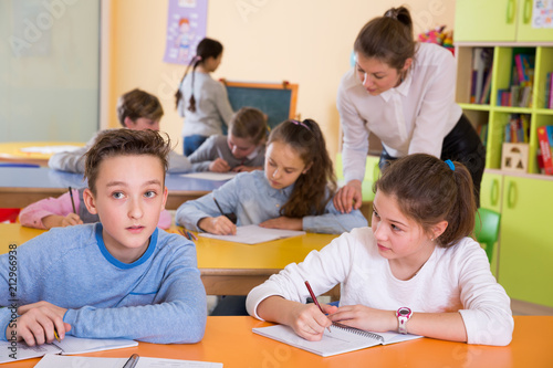 Teacher and schoolkids during lesson