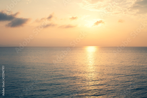 Sunset Sea over the Horizont. Beautiful Ocean Sunshine Landscape, Shimmering Twilight with yellow colors, Warm marine dusk Sun, Reflecting sunlight over the water © Artur