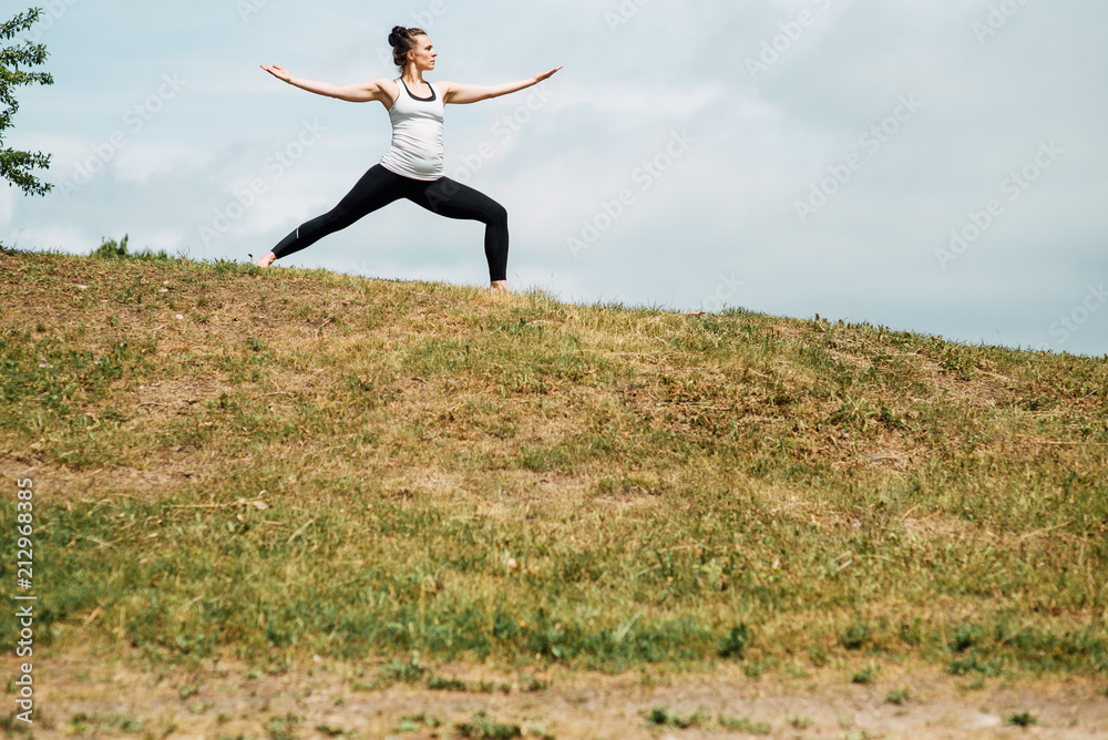 Young girl doing yoga in morning park.Woman Yoga - relax in nature Young girl doing yoga in morning park.Woman Yoga - relax in nature