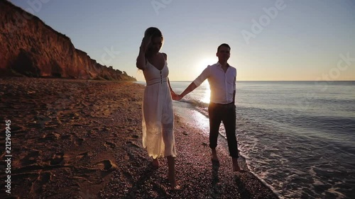 Romantic young couple enjoying beautiful sunset walk on the beach travel vacation, Krabi Thailand
