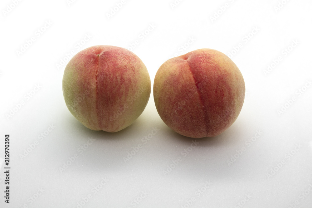 Two peaches isolated on white background.