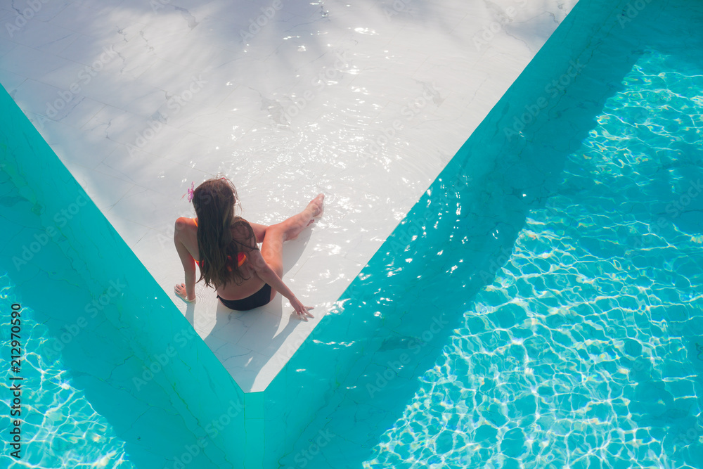 young beautiful woman in bikini relaxing in spa pool. aerial view