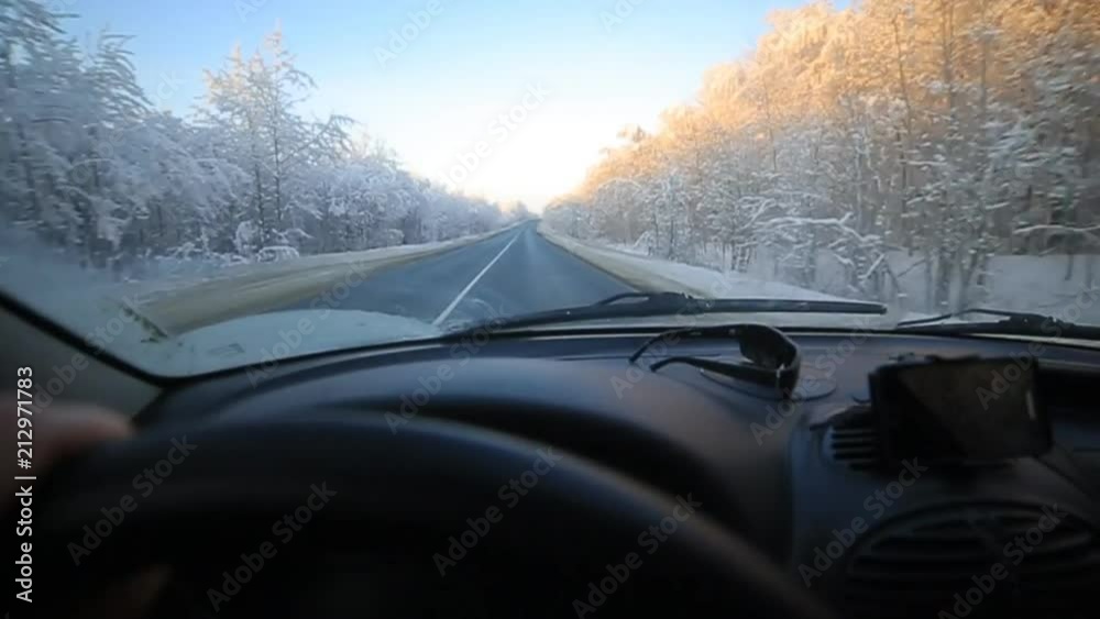 man slowly driving a car on a winter road. In winter, the majority of motorists still goes slow down and be careful. man slowly driving a car on a winter road. In winter, the majority of motorists still goes slow down and be careful.
