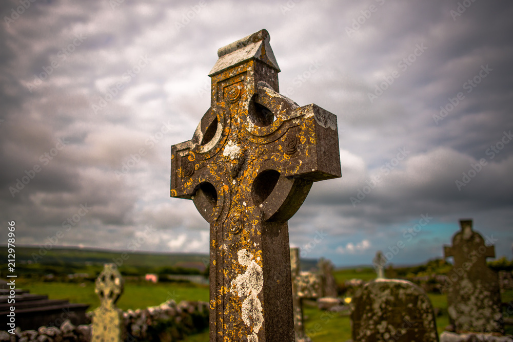 Old cemetery with Irish celtic cross, in Doolin, Ireland, Co. Clare. Old cemetery with Irish celtic cross, in Doolin, Ireland, Co. Clare.