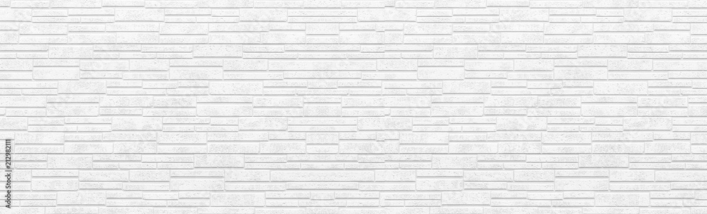 Fototapeta premium Panorama of white modern stone wall pattern and background