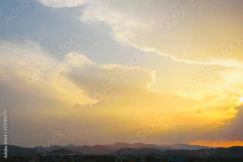 Beautiful sunset with the sun of orange tones behind the mountains and deep blue sky © Joaquin Corbalan