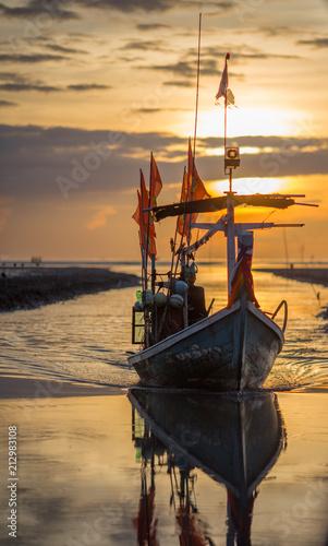 Fototapeta Naklejka Na Ścianę i Meble -  Nakhon Si Thammarat: August 6, 2017, fishing boat docked with beautiful morning light. Sunrise Beach, Tha Sala, Thailand
