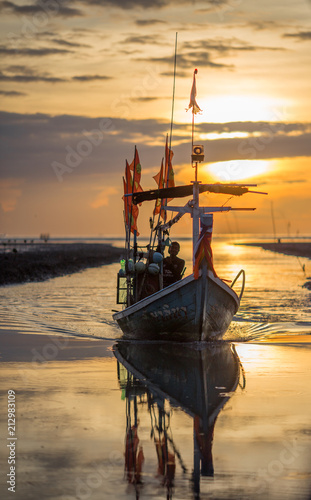 Fototapeta Naklejka Na Ścianę i Meble -  Nakhon Si Thammarat: August 6, 2017, fishing boat docked with beautiful morning light. Sunrise Beach, Tha Sala, Thailand