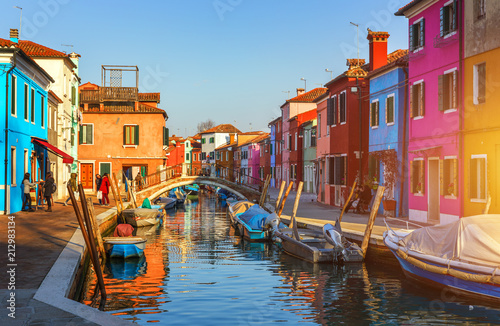 Lovely house facade and colorful walls in Burano, Venice. Burano island canal, colorful houses and boats, Venice landmark, Italy. Europe © daliu
