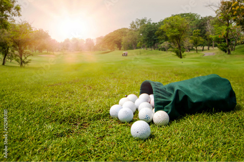 Golf Balls for training in green fabric bag on the golf course in morning. The concept of playing sport is to relax  in vacation day