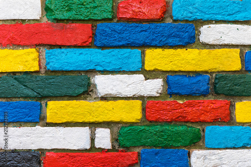 Colorful brick wall background. Rainbow colourful brick wall. Colorful brick wall pattern, painted bricks as urban design texture.