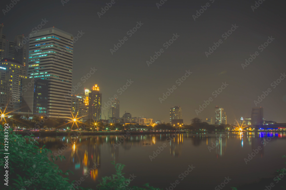 Fototapeta premium Colorful lights with high-rise buildings. Always seen by the park. Beautiful night