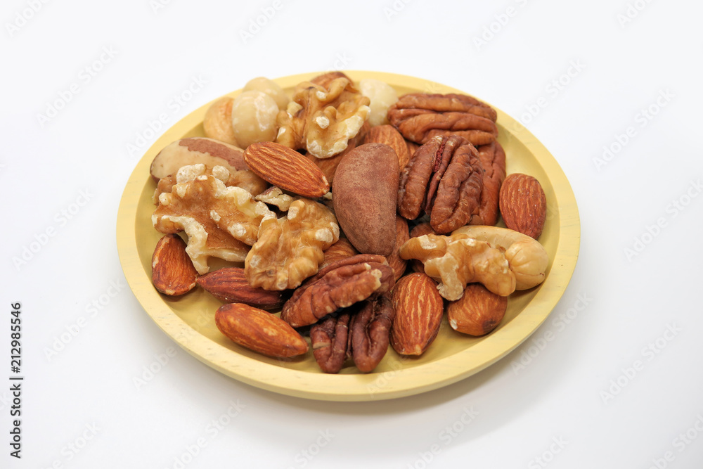 Yellow plate with mixed nuts Yellow plate with mixed nuts