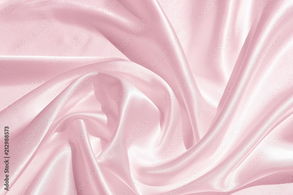 The texture of the satin fabric of pink color for the background The texture of the satin fabric of pink color for the background