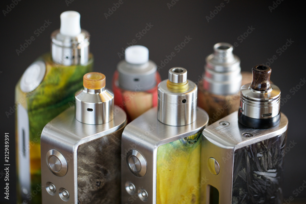 high end rebuildable dripping atomizers for flavour chaser on regulated  stabilized wood box mods, vaping device, vape gear, vaporizer equipment,  selective focus with shallow depth of field foto de Stock | Adobe
