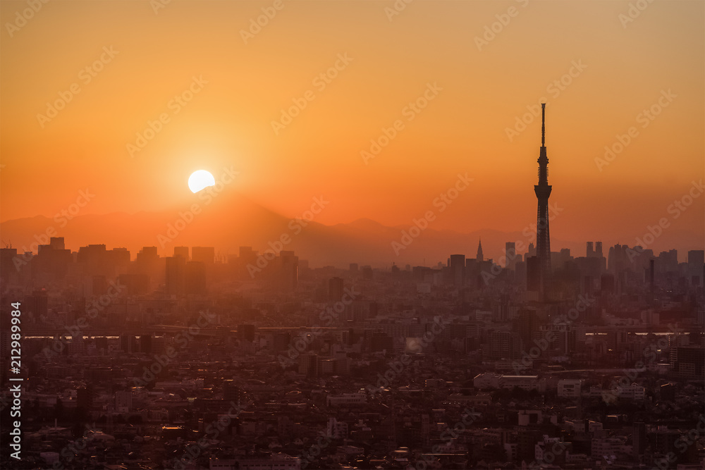 .Tokyo Fuji diamond with Tokyo Skytree landmark.  Diamond Fuji is View of the setting sun meeting the summit of Mt. Fuji