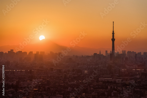 .Tokyo Fuji diamond with Tokyo Skytree landmark. Diamond Fuji is View of the setting sun meeting the summit of Mt. Fuji
