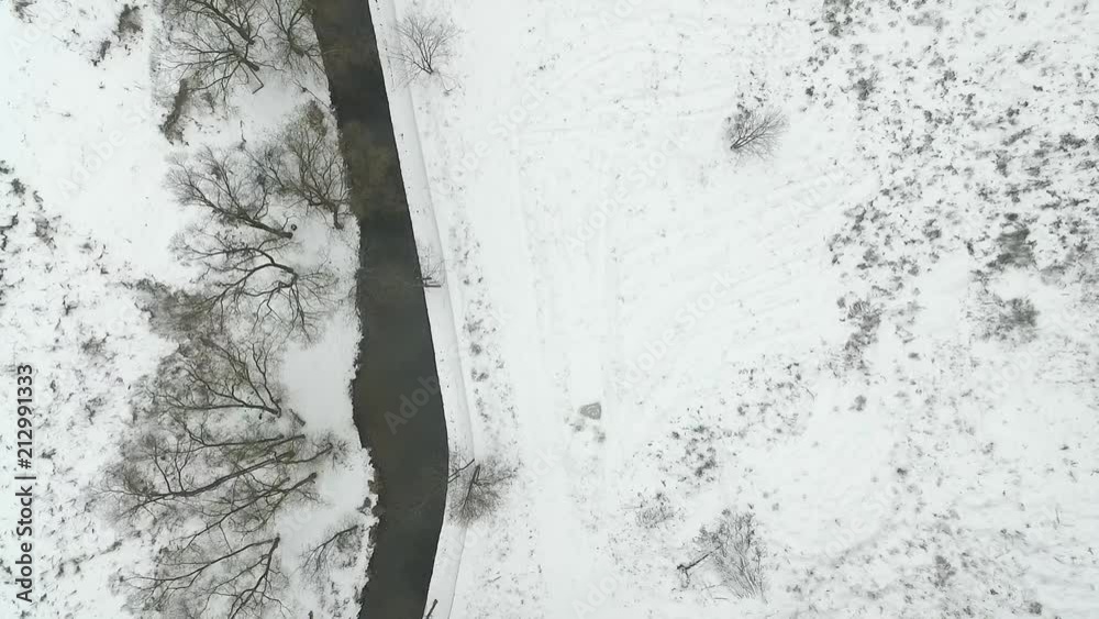 Aerial view of winter river. View from the top, snowy day. River is not frozen. Aerial view of winter river. View from the top, snowy day. River is not frozen.