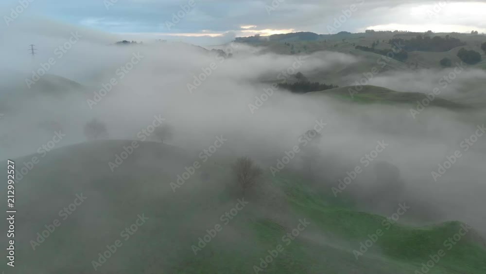 Aerial clip of a misty morning during sunrise in New Zealand.