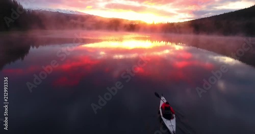 Aerial over kayaker on lake during sunrise photo
