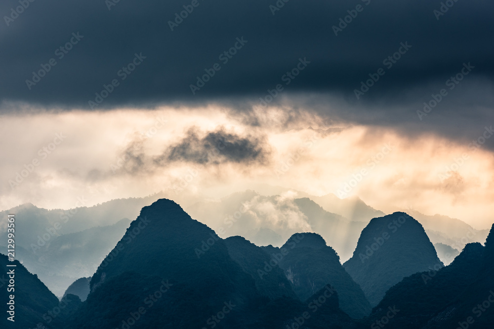 dramatic light and cloudscape above mountain top