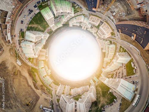 Helicopter drone shot. Aerial photography of a modern city over an area, a large crossroads, high-rise buildings, a park and roads. Panoramic city 360 shot from above