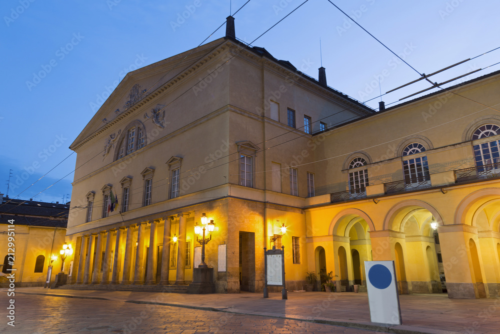 PARMA, ITALY - APRIL 17, 2018: The street of the old town at dusk and the Teatro Regio theater.
