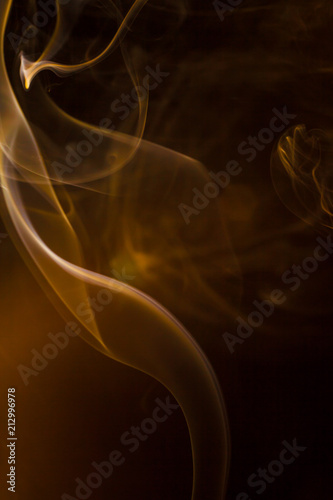 Gold smoke on black background.