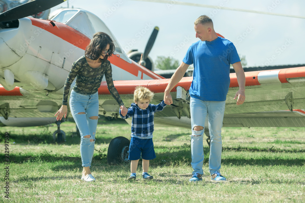 Obraz premium Mother and mothers day. Little child with mother and father celebrate mothers day. Mothers day on military air show. Family hold hands on mothers day.