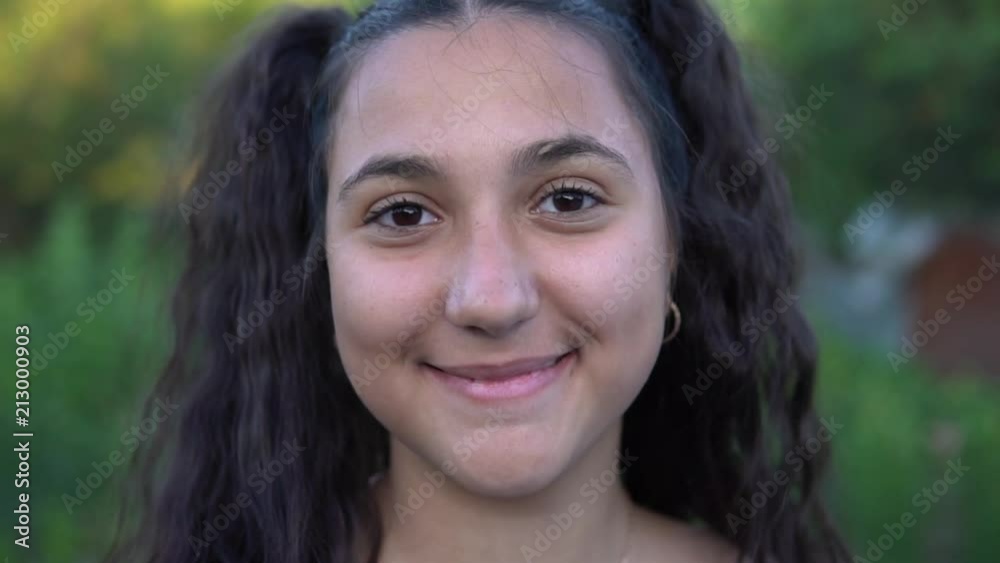 Portrait. Beautiful girl smiles in the camera. slow motion Portrait. Beautiful girl smiles in the camera. slow motion
