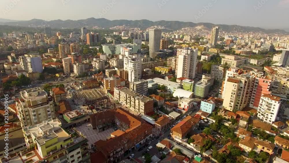 Beautiful fast aerial panorama shot flying backwards and panning across the city of Tirana, Albania in the morning Beautiful fast aerial panorama shot flying backwards and panning across the city of Tirana, Albania in the morning