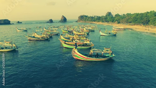 Indonesia traditional fishing boats docked in shores after fishing an aerial view, Papuma beach Jember photo