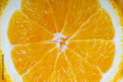 Orange fruit slice. Selective focus and crop fragment