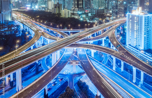 Photography aerial view of buildings and highway interchange at night in Shanghai city