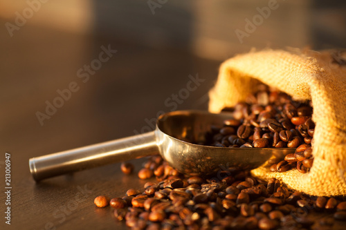Cup of coffee, bag and scoop on old rusty background