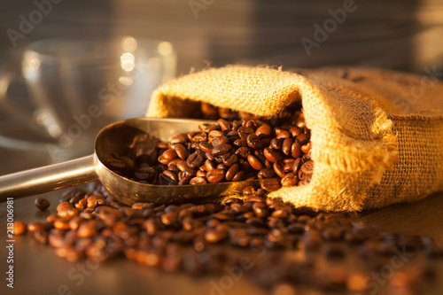 Bag with coffee beans on wooden background. Coffee concept. Fresh beans.