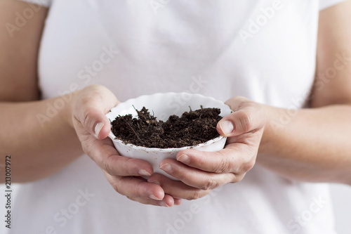 A woman holding soil