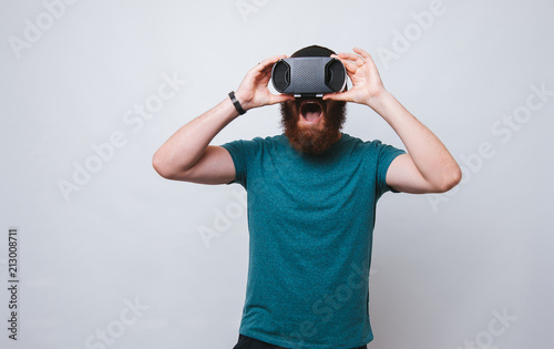 Amazed bearded man having VR experience, virtual reality