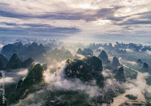 aerial view of cloudscape above farmland  river and roll of hills