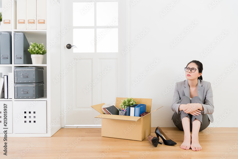 woman sitting on the wooden floor and thinkin woman sitting on the wooden floor and thinkin