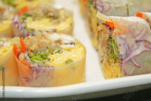 Thai fresh spring rolls in white plate on table background