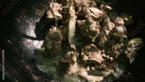 Cooking of pilaf. Grilled vegetables with chopped lamb in a cauldron, outdoor. stewed food. camping concept