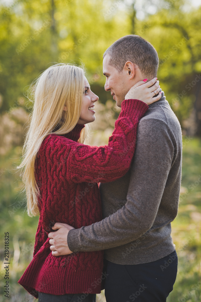 Fototapeta premium A young couple in love embracing against the background of reeds 1352.