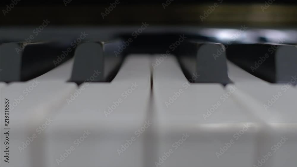 Close up moving shot of piano keys.