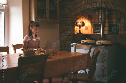 Woman using laptop at home photo