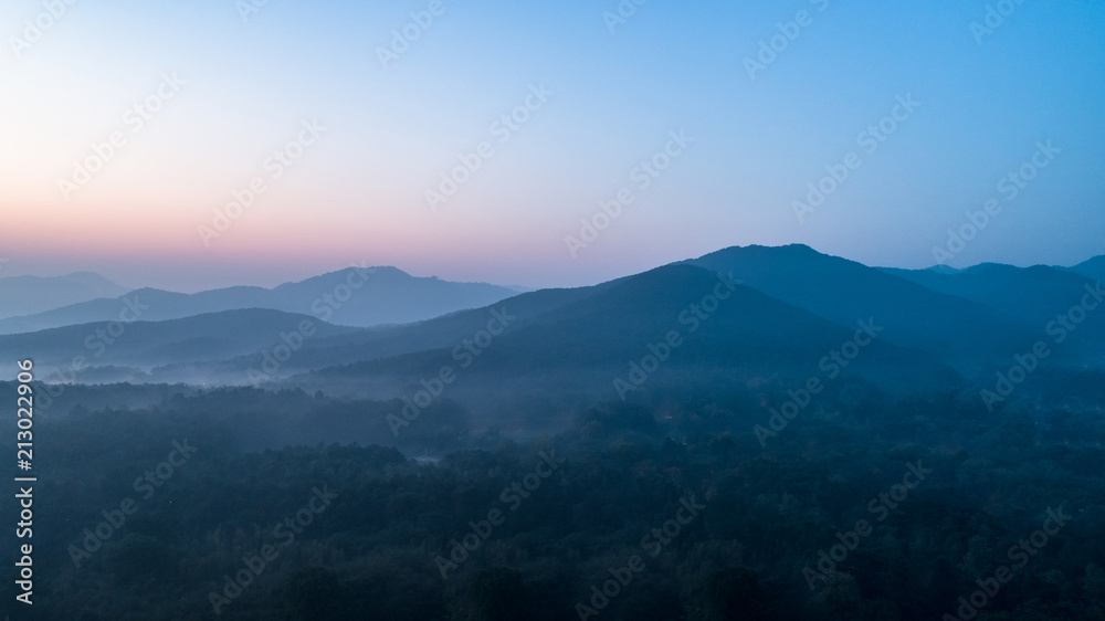rolling hills covered by mist in the dawn