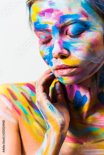attractive girl with colorful bright body art with closed eyes isolated on white