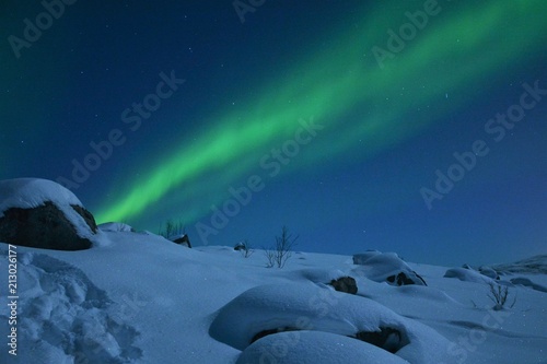 The northern lights (Aurora Borealis) over Seljelvnes, Troms by the sea and the snowy mountains © BAHADIRARAL