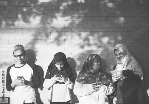 A group of Muslim students using mobile phones